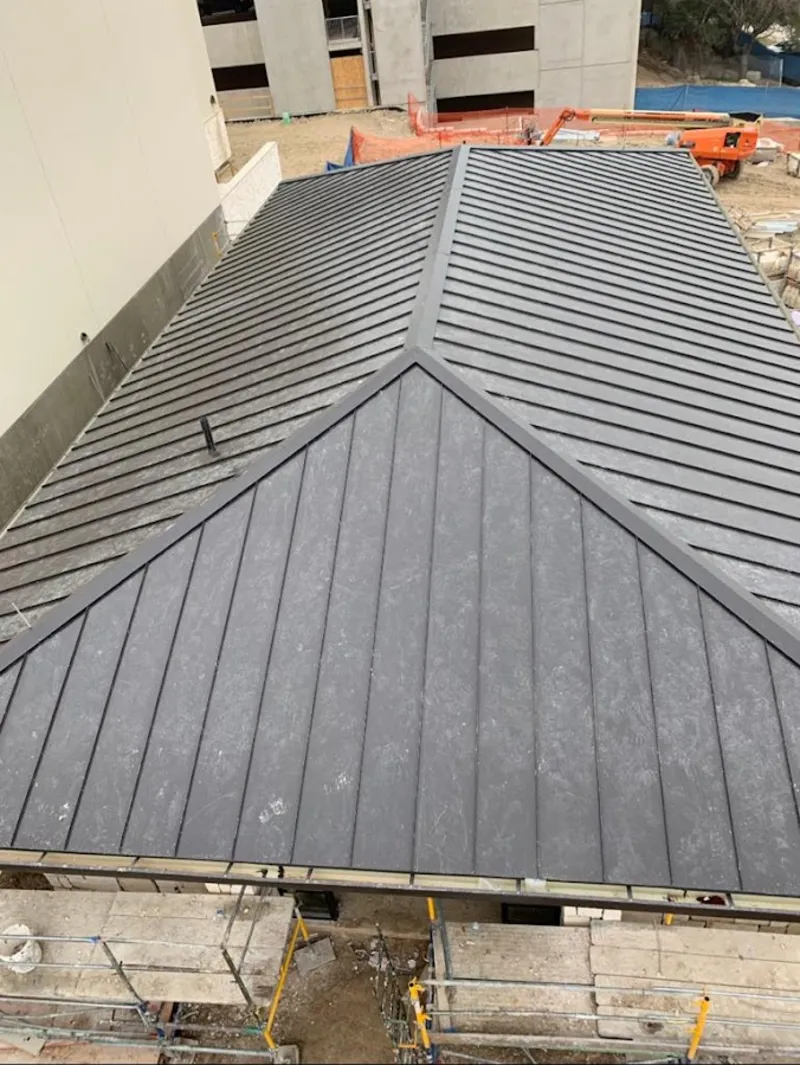 Commercial metal roof construction with crane equipment in East Honolulu