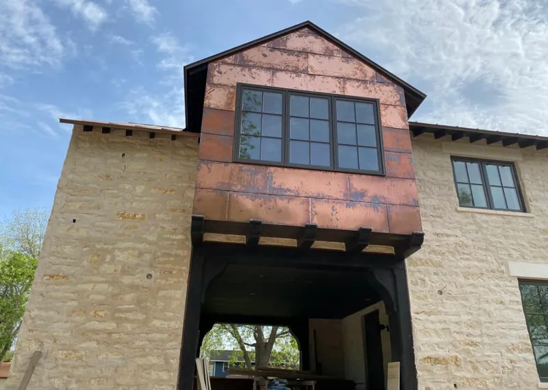 Copper metal panel facade on a stone building for Skylight Installation in East Honolulu